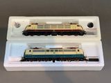 two model trains sitting in a box on a table