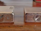 two silver toasters sitting on top of a wooden table
