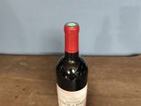 a bottle of wine sitting on a wooden table