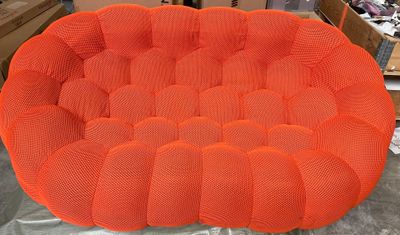 an orange chair sitting on top of a table in a room