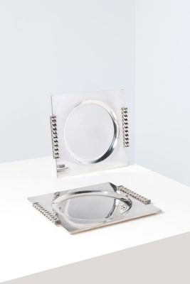 a silver plate and a silver plate on a white table
