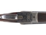a close up of a rifle with a wooden handle on a white background