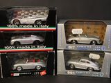 three boxed model cars are shown in boxes on a table