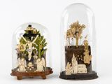 two glass cloches that have been placed on top of each other