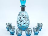 an image of a blue glass decanter set with four shot glasses
