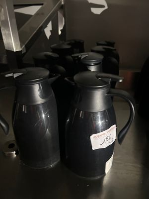bottles of coffee are lined up on a table in a kitchen