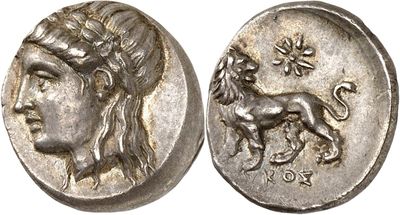 a silver coin with an image of a woman and a lion on it