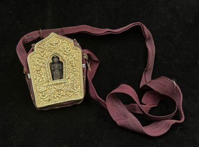 a small gold box with a picture of a person on it
