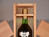 a bottle of liquor in a wooden box on a table