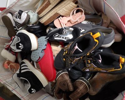 many pairs of shoes that are sitting in a bag