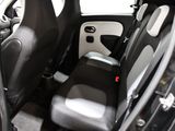 the interior of a small car with two black seats and a steering wheel