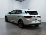 the rear end of a silver car in a white room