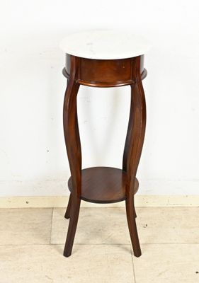 a small table with a marble top on the floor