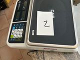 a picture of a scale with a calculator on top of it