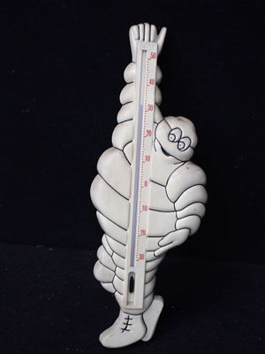 une image représentant un thermomètre, avec un homme tenant ce thermomètre à la main