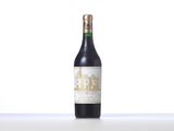 a bottle of wine sitting on top of a table next to a bottle of wine