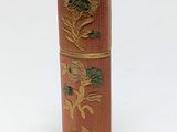 a small wooden box with a flower design on it