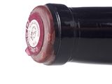 a close up of a wine bottle with a red cap