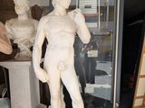a statue of a man that is standing in front of a glass door