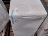a white refrigerator sitting on a pallet next to other appliances