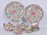 a group of plates and cups and saucers with flowers on them