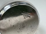 a close up of a silver cup on a table