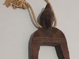 brown wooden horse shoe hanger with rope on white surface
