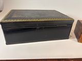 a black box sitting on a table next to a wooden box