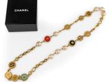 a chanel bracelet with pearls and a gold chain