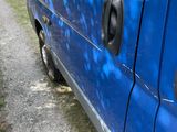a blue van that is parked on the side of the road