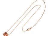a close up of a necklace with a chain on a white background