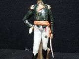figurine of a man in a green jacket and white pants