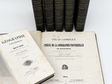 several old books are stacked on top of each other on a table