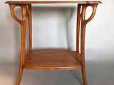 a small wooden table with a glass top on it