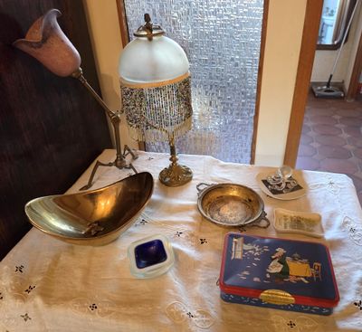 a table with a lamp, a book, and other items on it