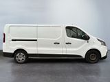 the white van is parked on the concrete floor in the room