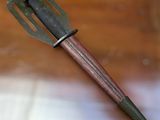 a metal fork with a wooden handle sitting on a table