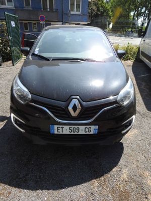 the front of a black car parked in a parking lot