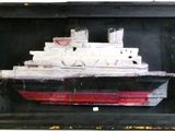a picture of a painting of a ship in a black frame