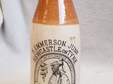 a brown and white bottle sitting on a white table
