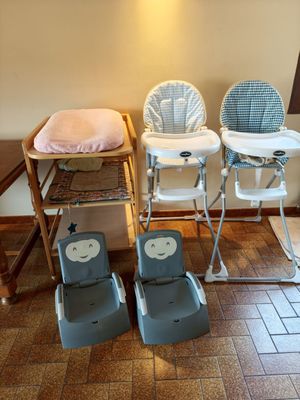 two baby high chairs and a baby chair in the room