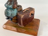 a statue of a woman sitting on top of a suitcase