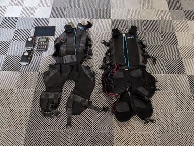 two pairs of scuba gear on the floor next to a cell phone