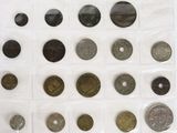 a lot of coins that are on a white surface