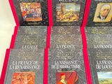 six books of french literature are lined up on a white surface