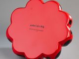 a red flower shaped box with a name on it