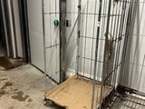 a metal cage with a metal platform in the middle of a room