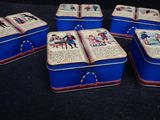 six blue tinned boxes with pictures of children on them