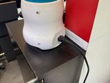 an image of a white and blue blow dryer on a black table