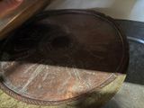 a metal tray with a design on it sitting on a table